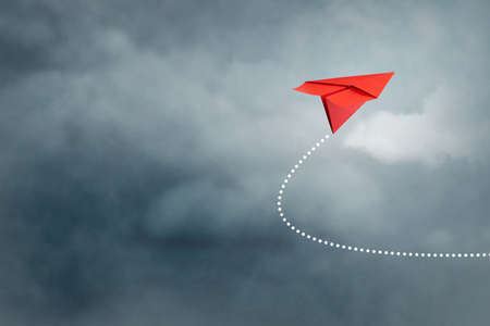 Paper plane flies in the cloudy sky. Travel concept, business success. copyspace. Travel, business, background.の写真素材