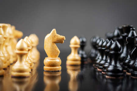 White chess knight, in front of the pawns. strategy concept. business. lifestyle. background.の写真素材