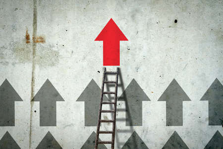 Arrows on a concrete wall. Red arrow, right direction. Stairs. leadership concept. team. business finance backgroundの写真素材