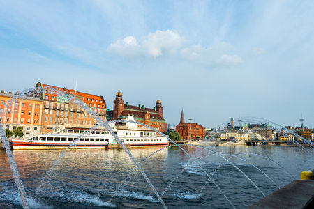 Malmo, Sweden. July 29, 2019, Beautiful fountain over the canals, against the backdrop of beautiful architecture. Malmo. Sweden landmarksのeditorial素材