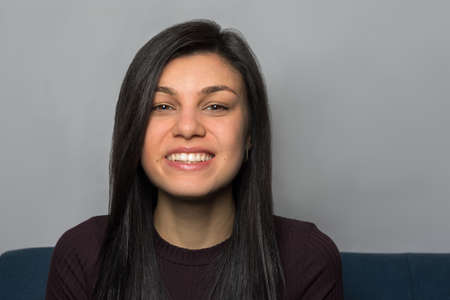 Portrait of a beautiful smiling young woman. people. lifestyle. gray background.の写真素材