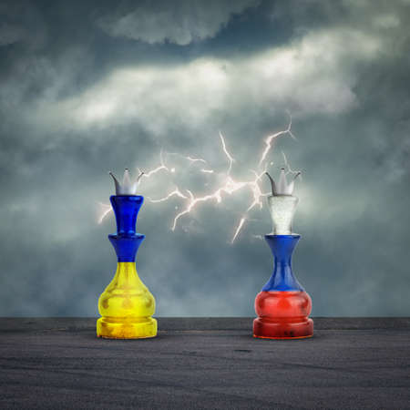 Chess Queens in the colors of the Flag of Russia and Ukraine. cloudy sky. Lightning. conflict. politics. economy. background.の写真素材