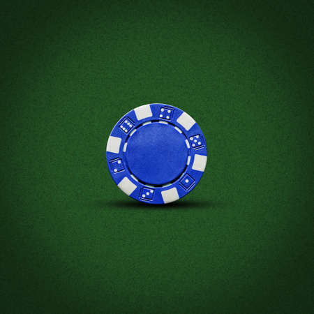 Blue poker chip, on a dark green background. Gambling. background.の写真素材