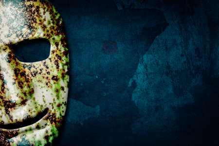 Old cracked theatrical mask on a grunge background. 3D illustration.Copy Space. emotions. Theatre.の写真素材