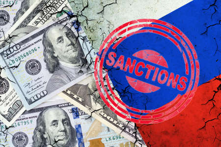 Dollar bills, and a cracked Russian flag. Sanction stamp. The concept of sanctions against Russia. finance. business.の写真素材