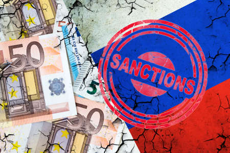 Euro bills, and a cracked Russian flag. Sanction stamp. The concept of sanctions against Russia. finance. business.の写真素材
