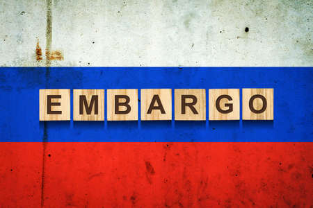 embargo. Word on wooden blocks. Against the background of the flag of Russia. business. politics. Economyの写真素材