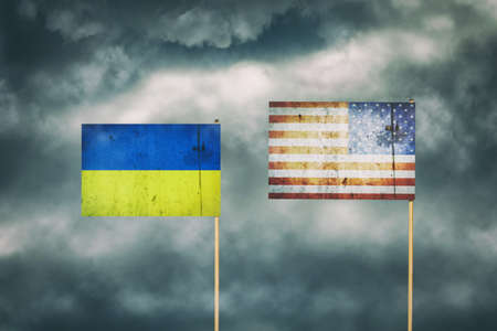 Flag of Ukraine and America. cloudy sky. politics. economy backgroundの写真素材
