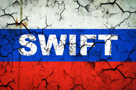Swift. The word on the cracked flag of Russia. blockade. sanctions. business. finance backgroundの写真素材