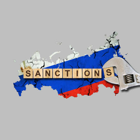 sanctions. Word on wooden blocks. Against the background of the map of Russia.Wrench. Isolated on a gray background. business. politics. Economyの写真素材
