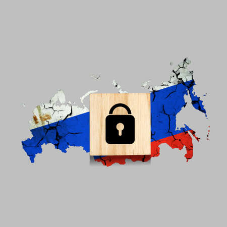 Lock, icon on a wooden block. On the background of the map of Russia. sanctions. insulation. Isolated on a gray background. business. politics. Economyの写真素材