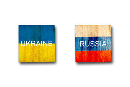 Flags of Ukraine and Russia on wooden blocks. isolated on white background. Conflict between Ukraine and Russia. war. politics. economy.の写真素材