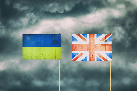 Flag of Ukraine and England. cloudy sky. politics. economy backgroundの写真素材