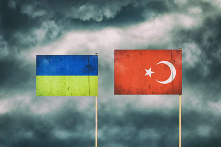 Flag of Ukraine and Turkey. Cloudy sky. Politics. Economy