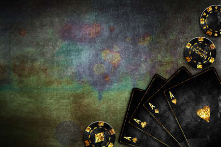 Vintage playing cards and poker chips, on a green grunge background. Four Ace. copyspace. playing cards. Gambling. background.の写真素材