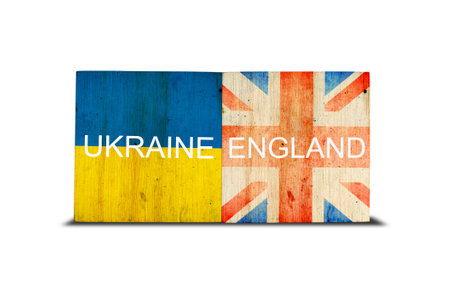 Flags of Ukraine and England on wooden blocks. isolated on white background. commonwealth. support. cooperation. politics. economy.の写真素材
