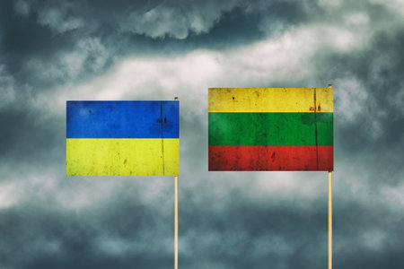 Flag of Ukraine and Lithuania. cloudy sky. politics. economy backgroundの写真素材