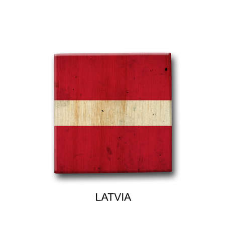 Latvia flag on a wooden block. isolated on white background. Signs and symbols. flags.の写真素材