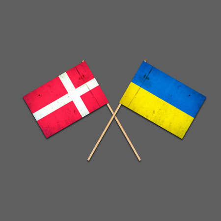 Flags of Denmark and Ukraine, on wooden sticks. Isolated on a gray background. international political relations. commonwealth. support. political economic background.の写真素材
