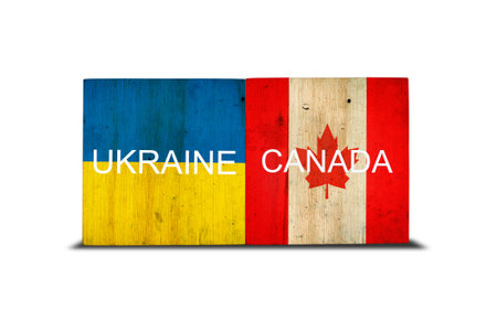 Flags of Ukraine and Canada on wooden blocks. isolated on white background. commonwealth. support. cooperation. politics. economy.の写真素材