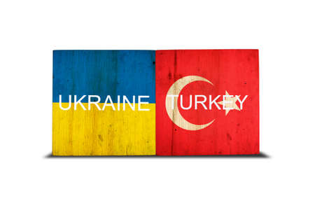 Flags of Ukraine and Turkey on wooden blocks. isolated on white background. commonwealth. support. cooperation. politics. economy.の写真素材