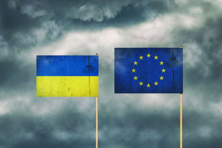 Flag of Ukraine and European Union. cloudy sky. politics. economy backgroundの写真素材
