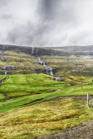 Cascade of waterfalls from beautiful mountains. Faroe Islands. Denmark. Europe. landscapes natureの写真素材