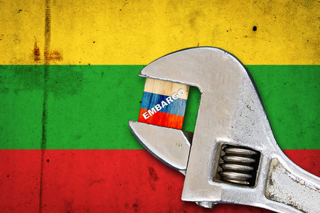 embargo. Word on a wooden block in the colors of the Russian flag. Clamped-wrench. Against the background of the flag of Lithuania. business. politics. Economyの写真素材