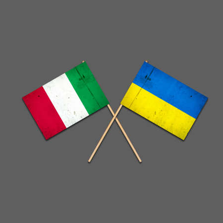 Flags of Italy and Ukraine, on wooden sticks. Isolated on a gray background. international political relations. commonwealth. support. political economic background.の写真素材