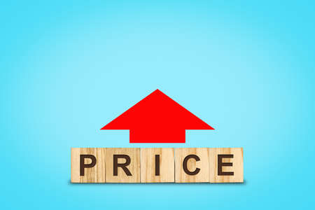 Concept, rising prices. Word on wooden blocks and red arrow up. Isolated on blue background. business. trade. inflation.の写真素材