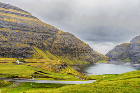 Sea bay, against the backdrop of beautiful mountains, and dramatic clouds. Faroe islands. Denmark. Europe. landscapes.の写真素材
