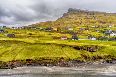 Small village, by the sea, at the foot of the mountain. Faroe Islands. Denmark. Europe. landscapes. Nature.の写真素材