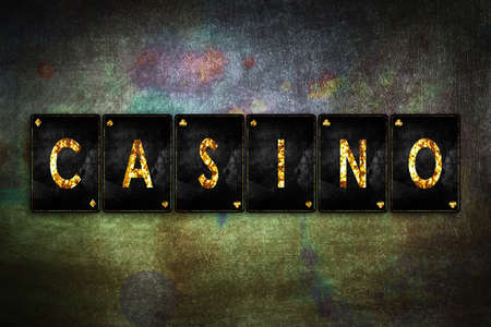 Casino, word, from alphabet on vintage playing cards, on a green grunge background. Casino. Gamblingの写真素材