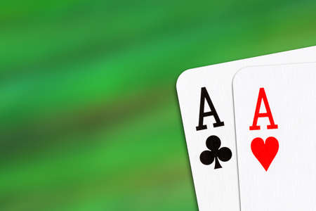 Playing cards, on a blur green background. Two Aces. Copy space. Place for text. Gambling. Background.の写真素材