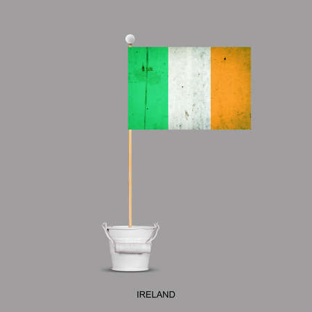 Grunge flag of Ireland on a stick, in a small bucket. Isolated on a gray background. Signs and symbols. Flags.Designの写真素材