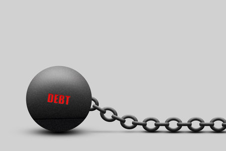Kettlebell with a chain, the word Debt, on a gray background. copy space. The severity of...