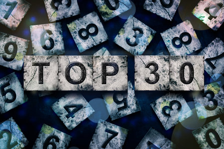 Top 30, words, above different numbers, on a dark blue background, with different letters. Alphabet on stone blocks.Rating. Rating concept.の写真素材