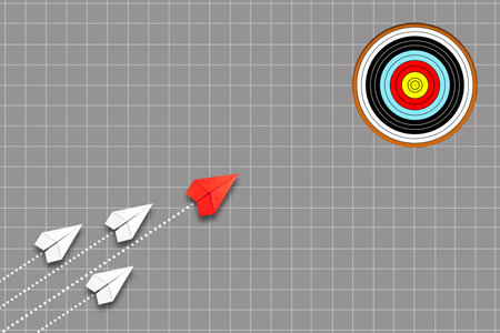 Group of paper planes is flying toward the target, led by a red plane on a gray background. The...