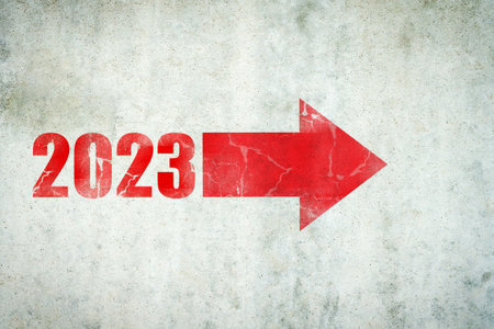 2023. Numbers, and arrow on a concrete wall. Copy space. Achievement of the goal, and success for...