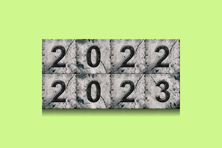 2022, 2023, numbers on stone blocks, on a bright green background. New Year concept. Festive...