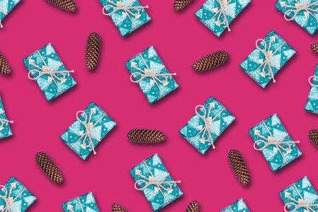 Christmas cones, and gifts on a bright pink background. Christmas background. Festive background.