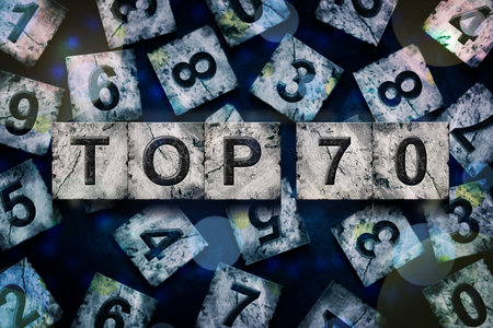 Top 70, words, above different numbers, on a dark blue background, with different letters. Alphabet on stone blocks.Rating. Rating concept. Background.の写真素材