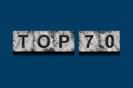 Top 70, words, above different numbers, on a dark blue background. Alphabet on stone blocks.Rating. Rating concept. Background.の写真素材