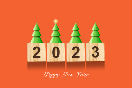 2023, numbers on wooden blocks, Christmas trees with a star.Bright orange background. New Year card. Christmas background. Festiveの写真素材