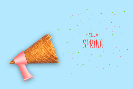 Ice cream cone, megaphone, and the words Hello spring. Blue background. The concept of the beginning of spring. Abstraction. Backgroundの写真素材