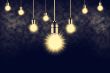 Dark background with glowing light bulbs and smoke.Copy space. Abstract background.の写真素材