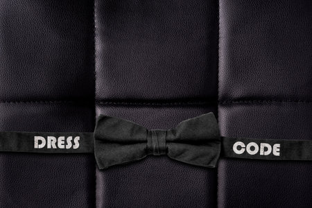 Dress code concept. Bow tie on black leather texture. Business. Lifestyle. Background.の写真素材