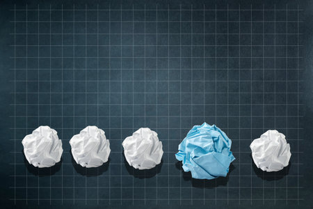 White and blue crumpled paper balls on dark blue background. New ideas. Copy space.New idea. Creative. Innovation. Business. Background.の写真素材