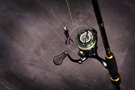 Spinning rod with reel on a dark background. Copy space. Fishing background.の写真素材