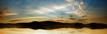 A beautifull lake panorama with blue-yellow skiesの写真素材